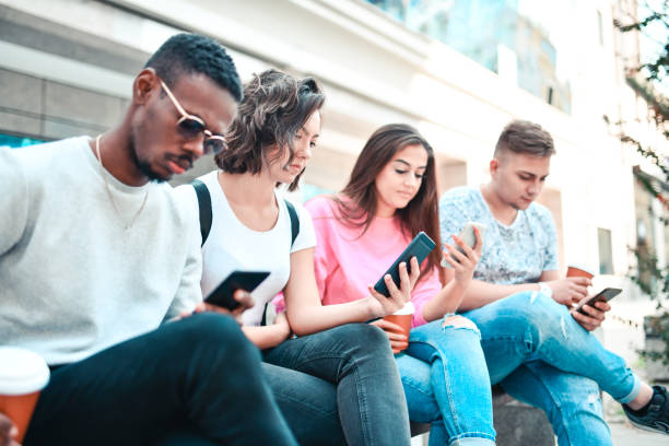 istock Multiethnic Students Not Interacting With Each Other And Looking At Smartphones After School 1321142973