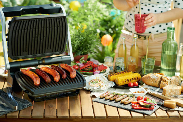 istock desk with electric grill and grilled sausages 1321143401