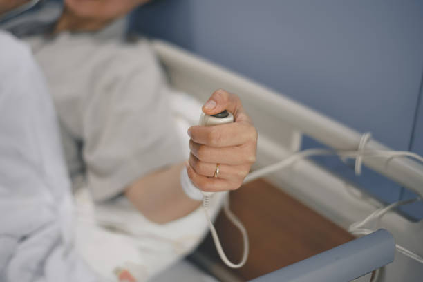 istock Patient pressing nurse call button holding help emergency health care 1321144357