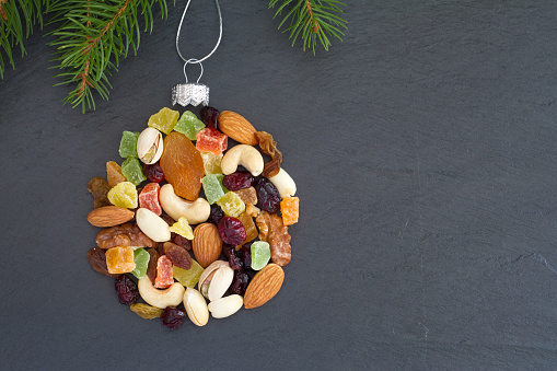 Christmas ball made of mix nuts and dried fruit, baking christmas background concept abstract