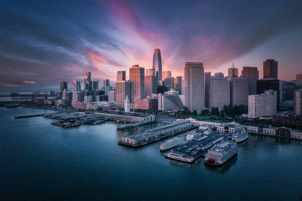 San Francisco Skyline Washed in Color Aerial view of a dramatic San Francisco Skyline washing in intense color . The embarcadero and the skyscrapers washed in purple, pink and blue tones. san francisco california stock pictures, royalty-free photos & images