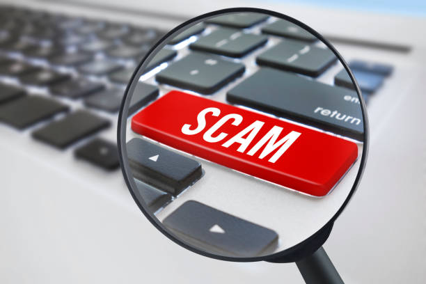 Scam key Looking at a “scam” key with magnifying glass on laptop Scams and Fraud stock pictures, royalty-free photos & images