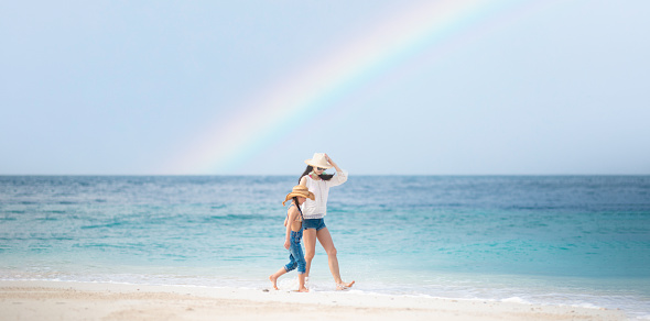 Mother and daughter playing on the rainbow beach