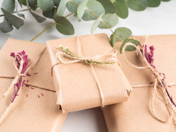 istock Wrapped gift boxes in craft paper with dried flowers decor 1321152413