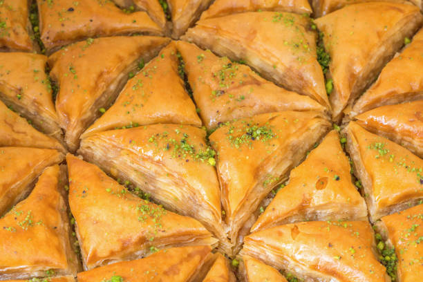 istock Top view of triangular-shaped almond baklava with pistachio toppings 1321154786