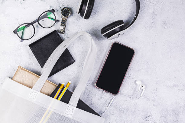 istock White women's leather bag with eyeglasses book and smart watch, phone, earphone, notepad. 1321155671