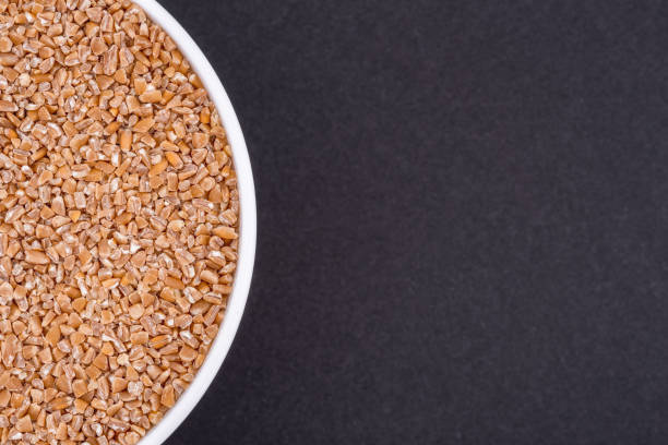 istock White glass bowl of wheat groats. 1321157087