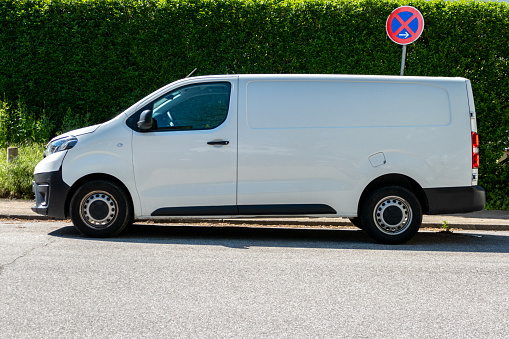 Hamburg, Germany - June 01. 2021: A white delivery van is parked somewhere in Hamburg - City,  at noon in the parking lot in the prohibited zone