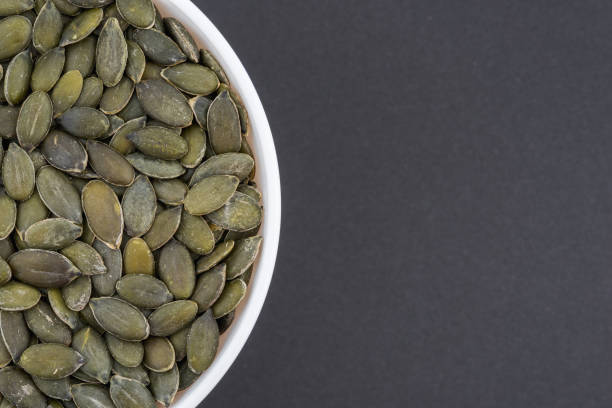 istock Pumpkin seeds in a white glass bowl. 1321157245