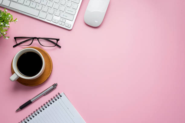 istock Top view of pink workspace with work equipment flat paste copy space. 1321158058