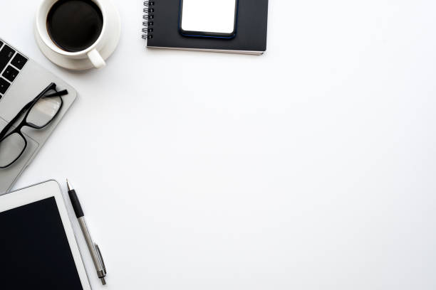 istock Top view of a creative workspace with a smartphone a coffee tablet placed. Desk white 1321158080