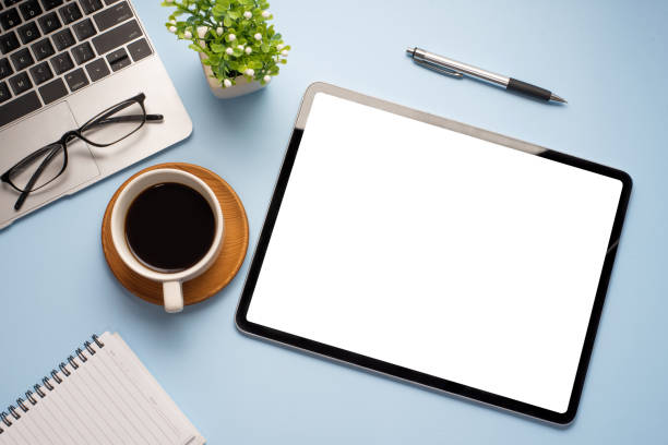 istock Digital tablet a blank white screen is placed on the blue wooden table at the office. Mock up. 1321158085