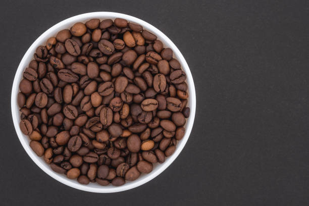 istock White glass bowl of coffee beans. 1321158408