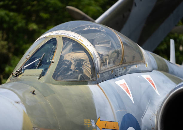 istock Abandoned old Bucaneer RAF fighter jet from the cold war era. Folding wings for use on aircraft carrier focus on cockpit and pilots seat with jet engines and radar in view. 1321160265