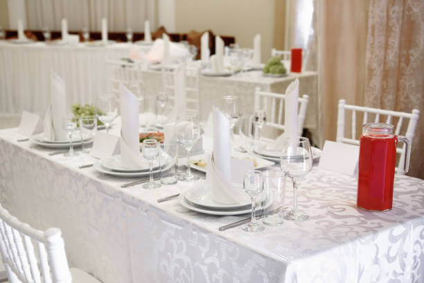 istock Table setting with sparkling wineglasses, plate with white napkin and cutlery on table, copy space. Place set at wedding reception. Table served for wedding banquet in restaurant 1321160375