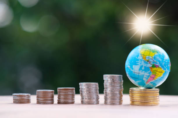 istock saving money concept, stacking coins with globe on green bokeh background, Advertising coins of finance and banking, business growth concept 1321161012