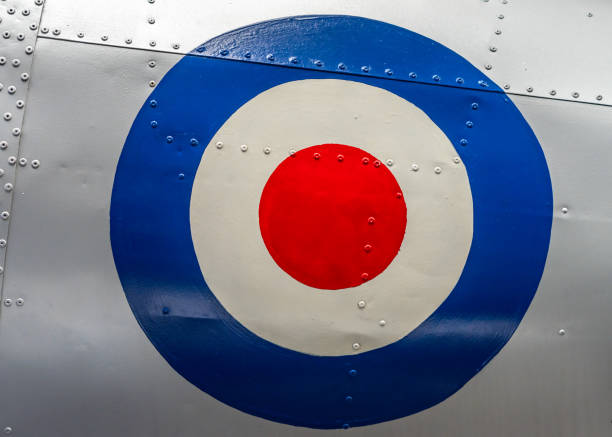 Large retro RAF target symbol on abandoned old aeroplane. Silver metal fuselage with rivets on historic decommissioned fighter plane from WW2 Large retro RAF target symbol on abandoned old aeroplane. Silver metal fuselage with rivets on historic decommissioned fighter plane from WW2 shiny and clean. raf stock pictures, royalty-free photos & images