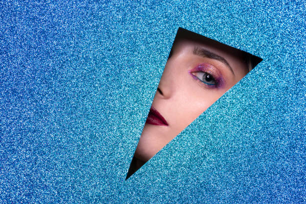 istock Beautiful attractive blond young woman light blue eyes posing with blue glossy foreground - Studio photography of pretty sensual girl looking at camera 1321161087