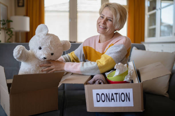 istock Placing a teddy bear into a charity donation box 1321162170
