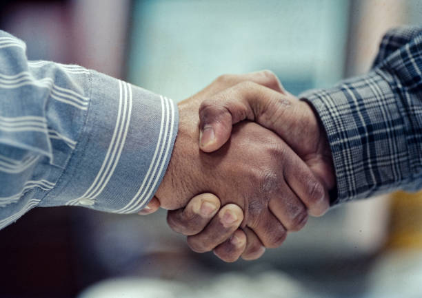 Business Shaking hands greeting Close-up of businesspeople handshaking stock photo