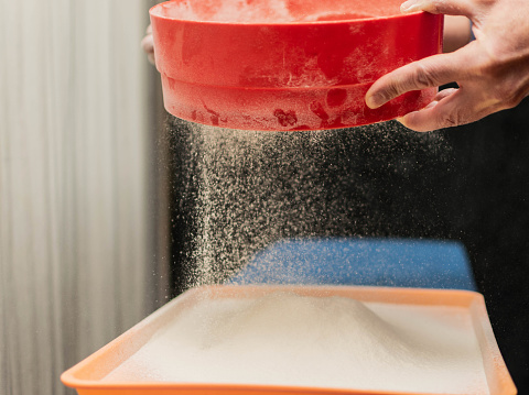 Man Using Sieve A Man Sows Flour Through A Sieve Stock Photo - Download Image Now - 50 ...