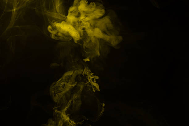istock Yellow and pink steam on a black background. 1321162595