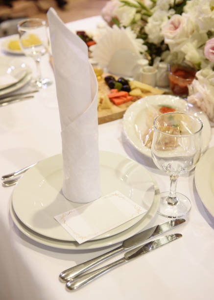istock Table setting with sparkling wineglasses, plate with white napkin and cutlery on table, copy space. Place set at wedding reception. Table served for wedding banquet in restaurant 1321163687