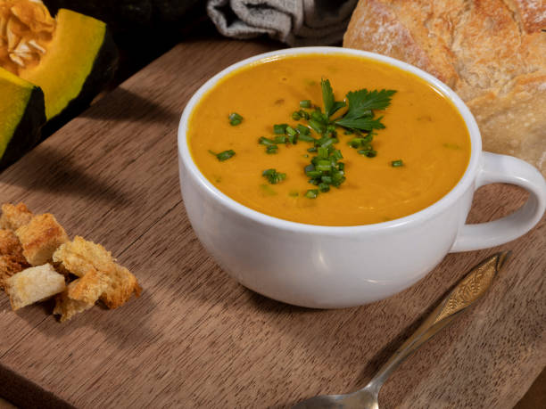 istock Pumpkin broth on wooden background 1321164031