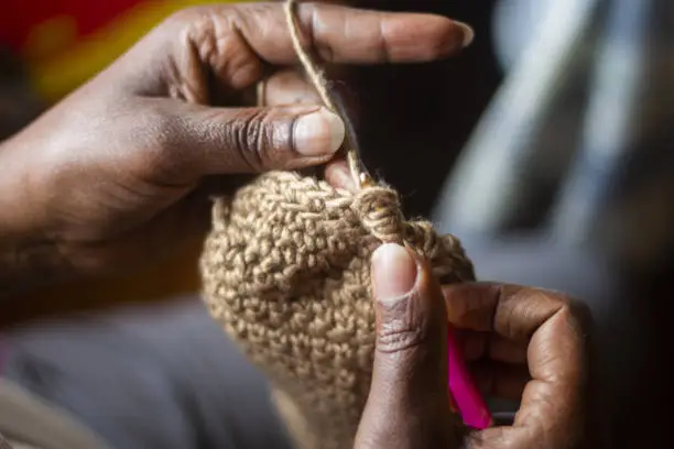 Photo of Close up of a woman's hand crocheting.