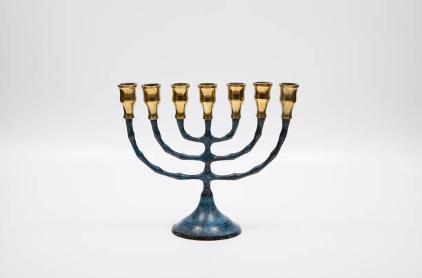 istock A small blue and gold menorah on a white background. 1321166322