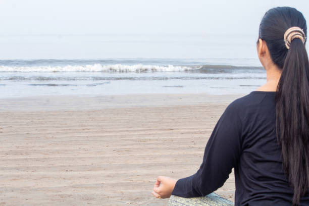 istock Woman practicing yoga at the beach 1321169664