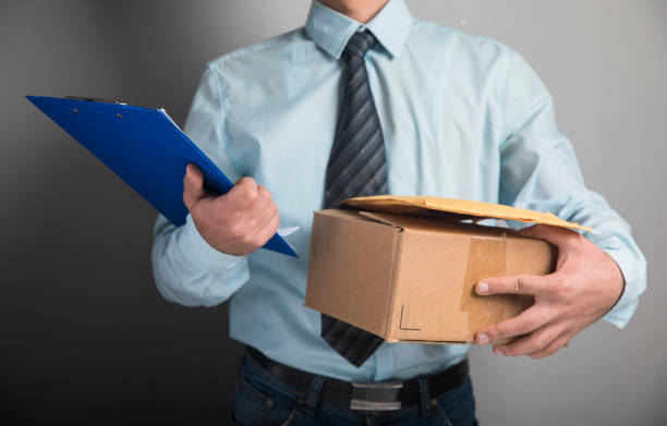 istock the courier holds the parcel and papers 1321170053