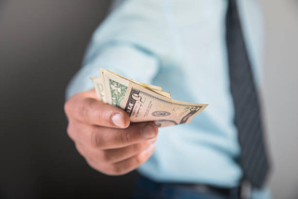 istock man gives money 1321170092