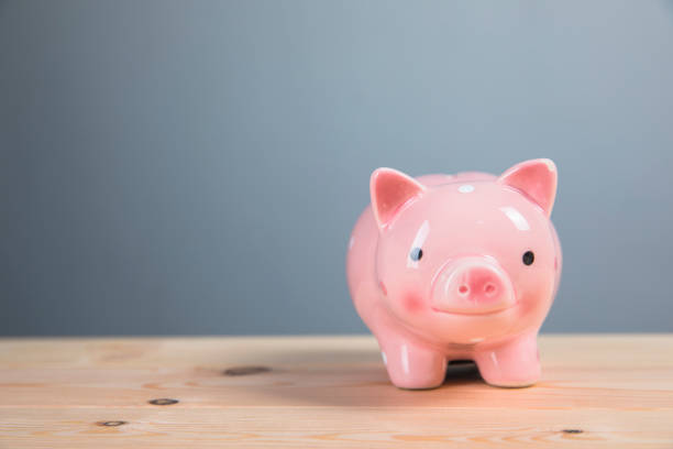 istock piggy bank on wooden table 1321170235