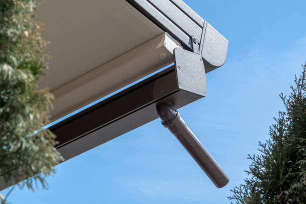 istock canvas awning with metal frame and drainage pipe against blue sunny sky. modern shading for house 1321171149