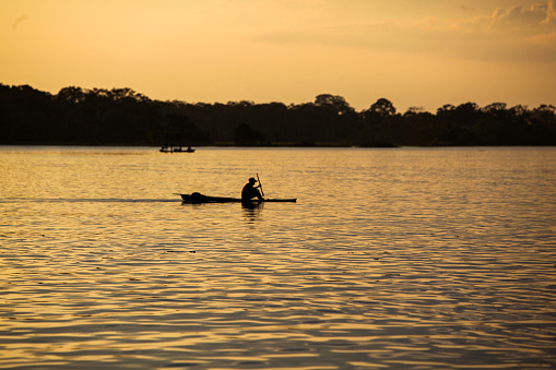 Fisherman returning home at dawn in the Amazon river.