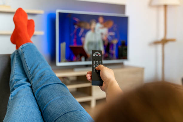 istock Woman changing channels while relaxing on sofa at home. 1321174008