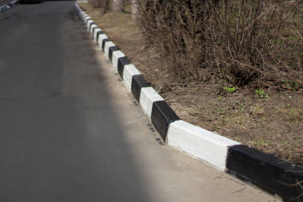istock Marked border. Black and white painted road curb. 1321175507