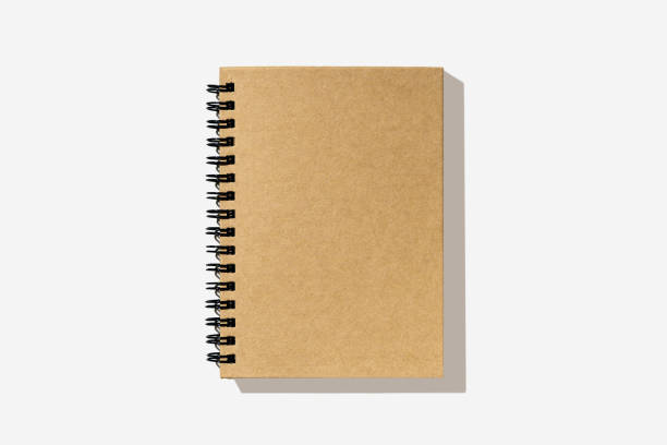 istock Mockup. Blank paper notebook on white background. Top view with copy space. Office desk table concept. 1321177425