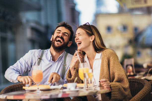 istock Young couple sitting in a restaurant eating pizza 1321177593