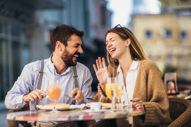 istock Young couple sitting in a restaurant eating pizza 1321177818