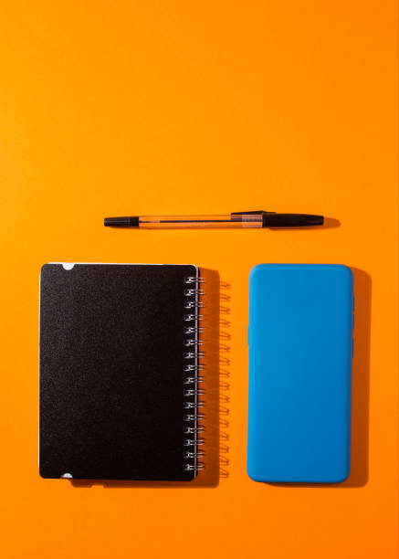 istock smartphone with white screen on orange background, work utensil 1321178966