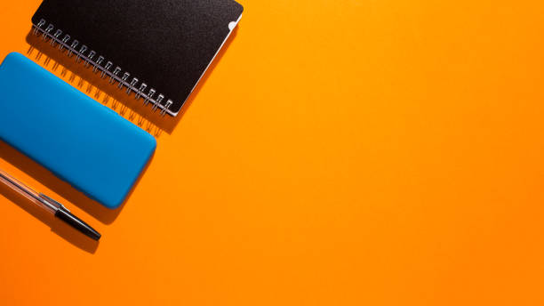 istock smartphone with white screen on orange background, work utensil 1321179037
