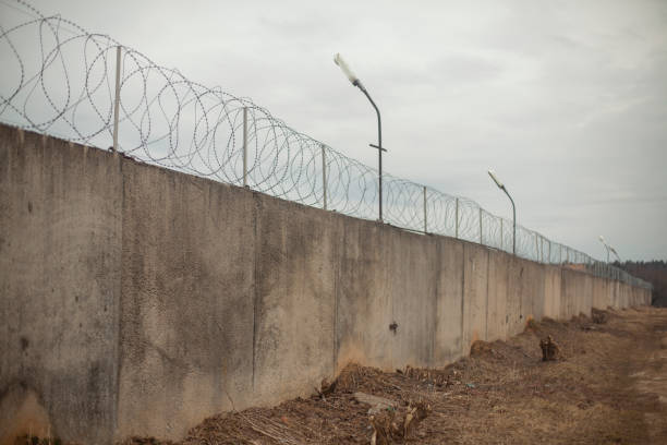 istock Fence with barbed wire. Fencing around the territory. 1321179291