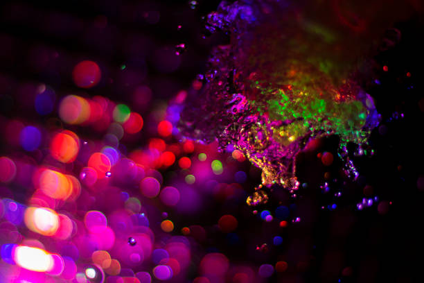 istock Colored water texture. Splashes of water lit in different colors. 1321179417