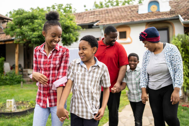 istock Family holding hands while walking and smiling 1321179945