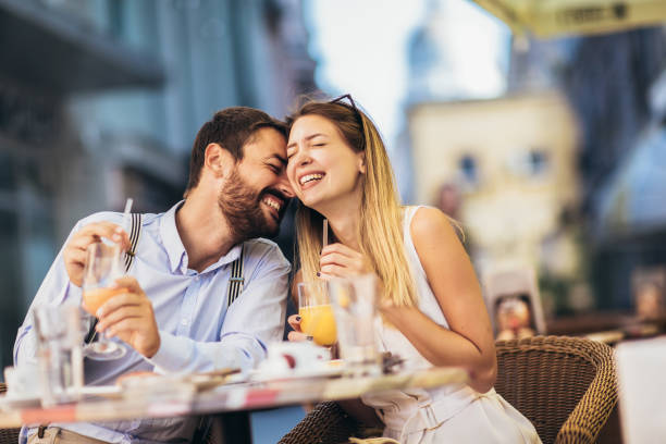 istock Young couple sitting in a restaurant eating pizza 1321180216