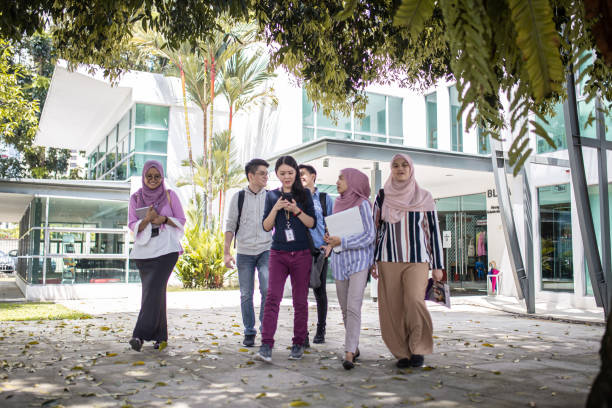 istock Group of Asian university student walking out from education building talking 1321180479