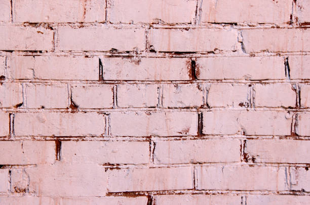istock Texture of a brick wall coated with red and pink paint 1321184123