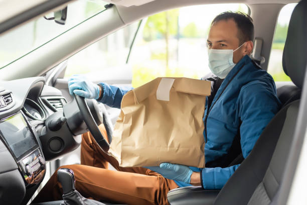 istock Delivery driver driving with parcels on seat 1321184709